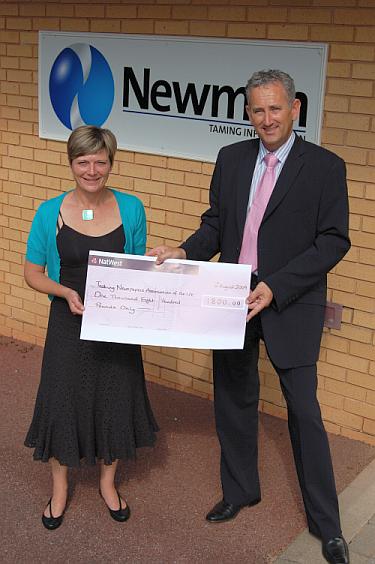 Cheryl Johnson, Communications Manager, National Talking Newspapers and Magazines receives a cheque for £1,800 from Newman Business Solutions' Managing Director, Andrew Deadman.