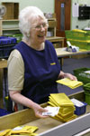 Anne Faulkner, a volunteer sorting tape wallets in the production department.